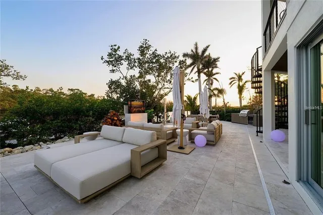 a view of swimming pool with outdoor seating and plants