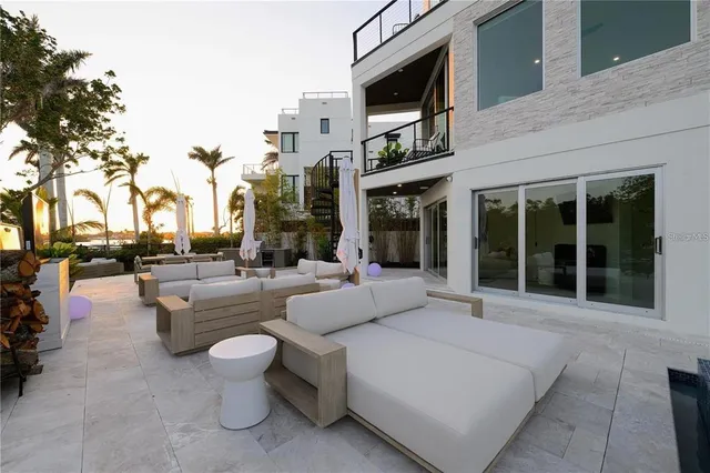 a building outdoor space with patio furniture and potted plants