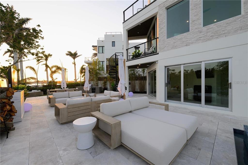 1406 Tangier Way Sarasota, FL 34239 - Photo 15 of 58 a building outdoor space with patio furniture and potted plants