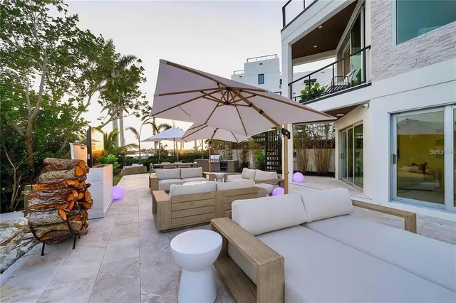 a view of a patio with chairs and potted plants