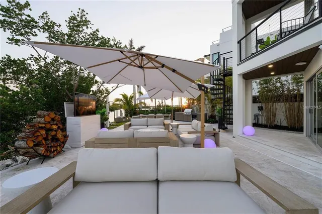 a view of a building with a yard and sitting area