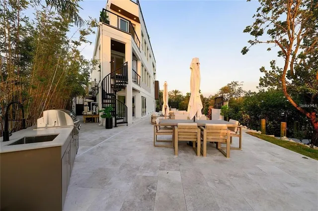 a view of a patio with couches table and chairs and potted plants