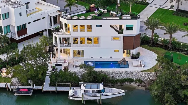 a aerial view of a house with swimming pool and a garden