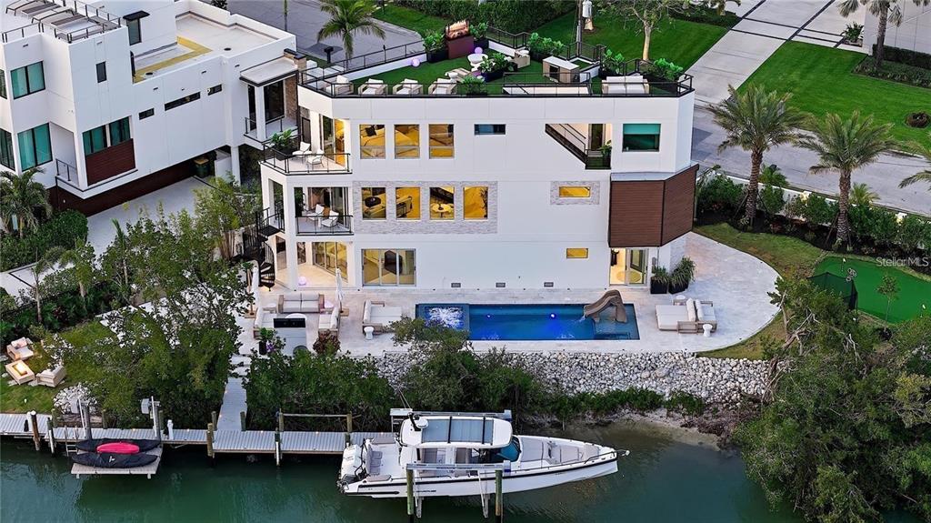 1406 Tangier Way Sarasota, FL 34239 - Photo 2 of 58 a aerial view of a house with swimming pool and a garden