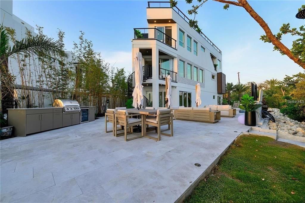 1406 Tangier Way Sarasota, FL 34239 - Photo 21 of 58 a view of a building with a yard and sitting area