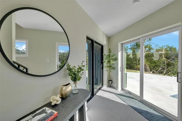 a kitchen with a dining table chairs cabinets and wooden floor