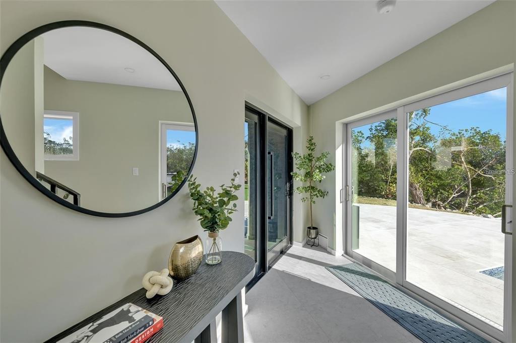 1406 Tangier Way Sarasota, FL 34239 - Photo 26 of 58 a living room with furniture and a mirror