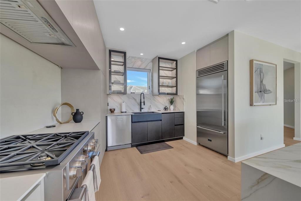 1406 Tangier Way Sarasota, FL 34239 - Photo 30 of 58 a kitchen with stainless steel appliances granite countertop a stove and a refrigerator