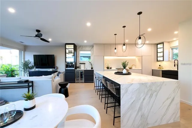 a bathroom with a granite countertop sink a toilet and shower