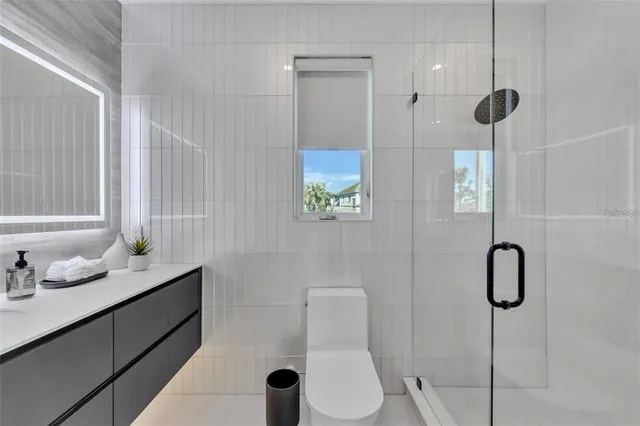 a bed room with a bed mirror and a large window