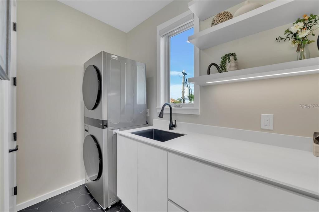1406 Tangier Way Sarasota, FL 34239 - Photo 48 of 58 a bathroom with a sink and a mirror