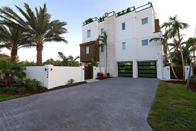 front view of a house with a yard and a garage