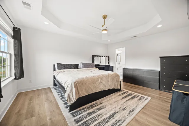 a bedroom with a large bed and a chandelier