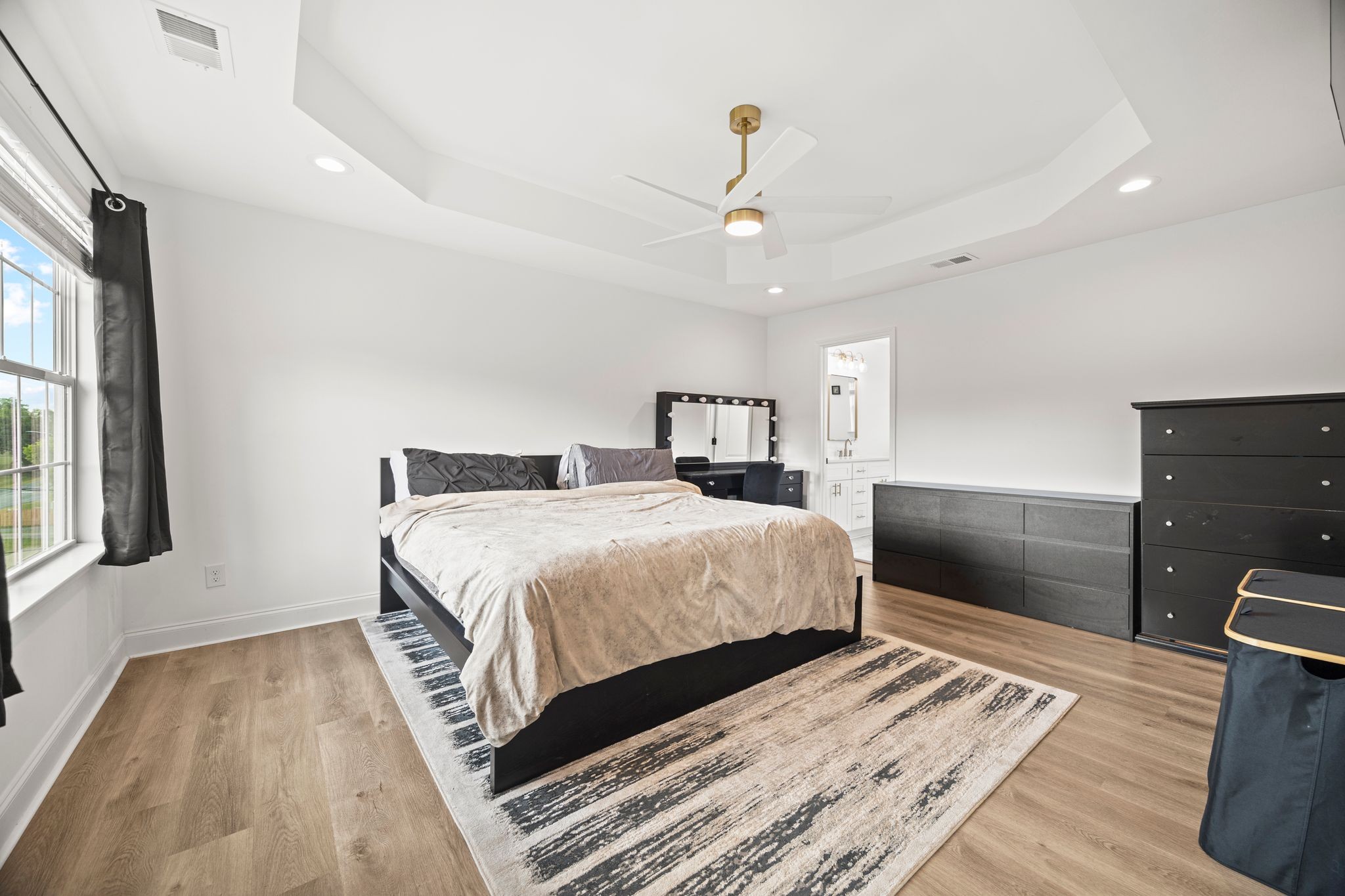 420 Larkin Springs Road Madison, TN 37115 - Photo 12 of 30 a bedroom with a large bed and a chandelier