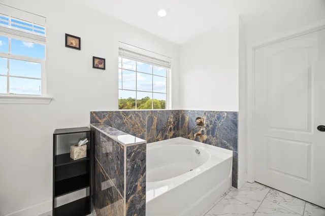 a bathroom with a bathtub and a shower