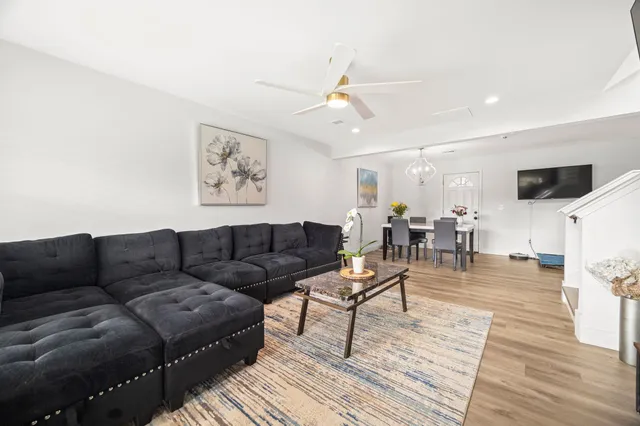 a living room with furniture and wooden floor