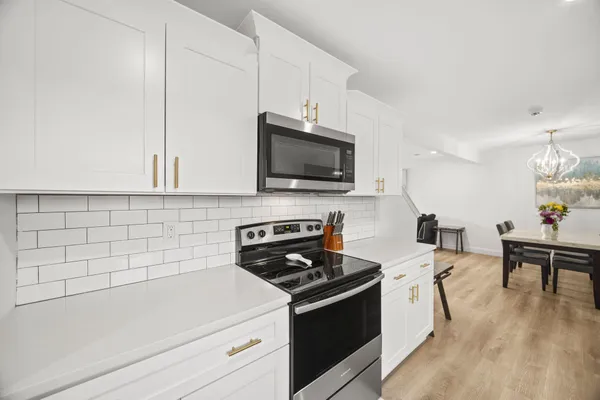 a kitchen with a sink a stove and cabinets