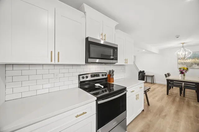 a kitchen with a sink a stove and cabinets