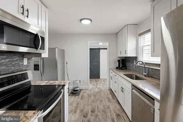 a kitchen with a sink stove and microwave