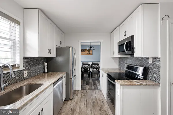 a kitchen with a sink stove and refrigerator