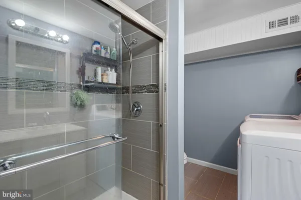 a bathroom with a tub and shower