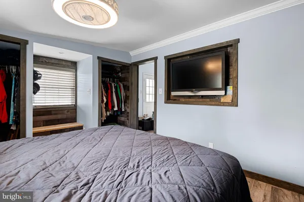 a bedroom with a bed and a television