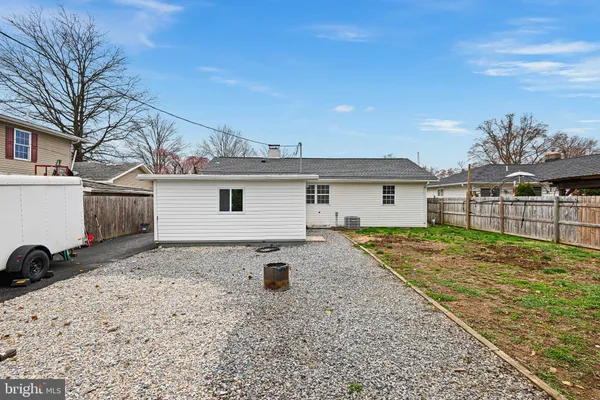 a view of a backyard with a barbeque grill and plants