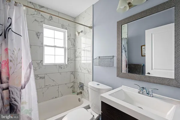 a bathroom with a sink toilet tub and shower