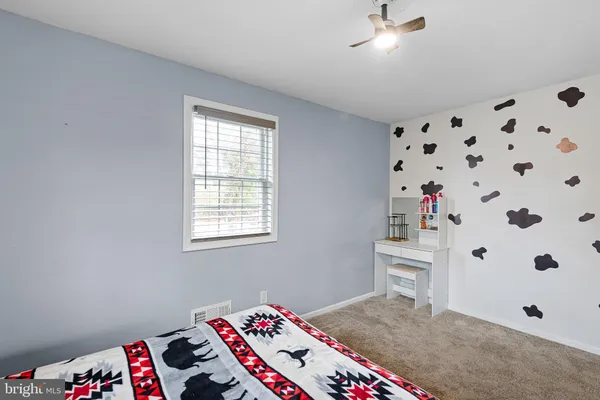 a room with a bed and a dresser