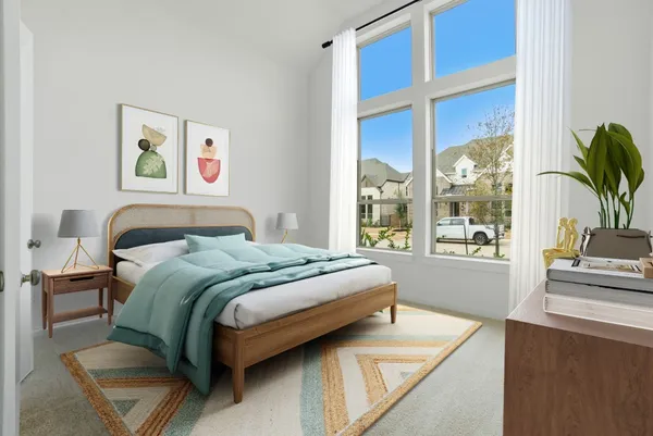 a bedroom with a bed and a large window