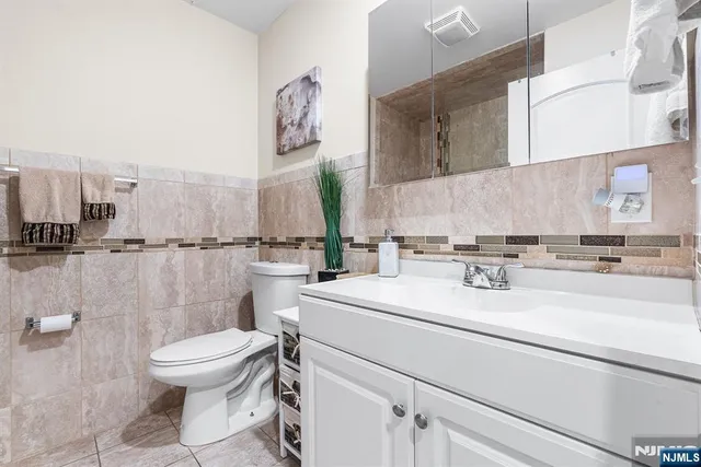 a bathroom with a sink a toilet and a mirror