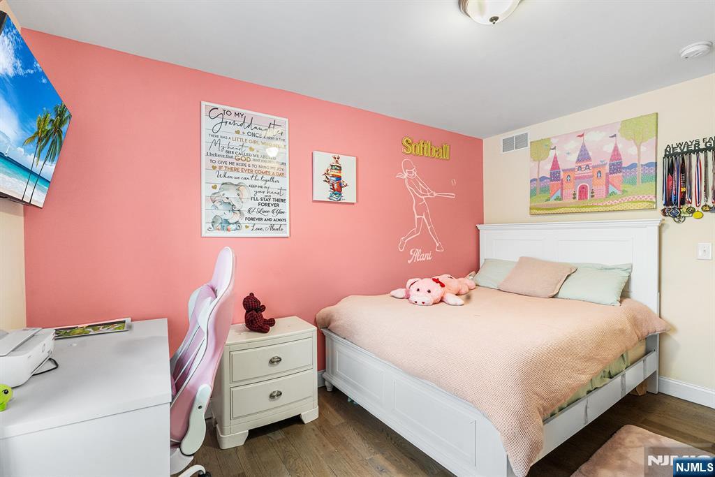 128 Baltimore Avenue Hillside, NJ 07205 - Photo 16 of 50 a bedroom with a bed and a dresser