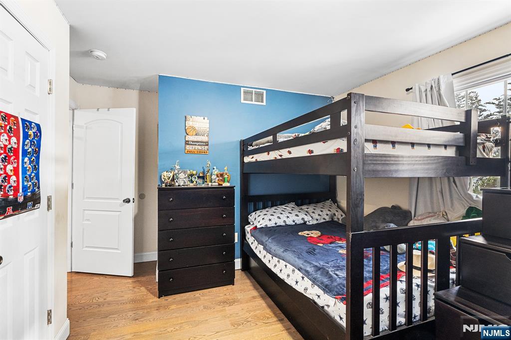 128 Baltimore Avenue Hillside, NJ 07205 - Photo 18 of 50 a bedroom with a bed and a window