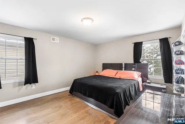 a bedroom with a bed lamp and window