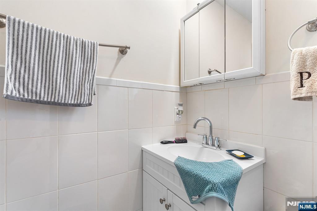 128 Baltimore Avenue Hillside, NJ 07205 - Photo 24 of 50 a bathroom with a sink and washing machine