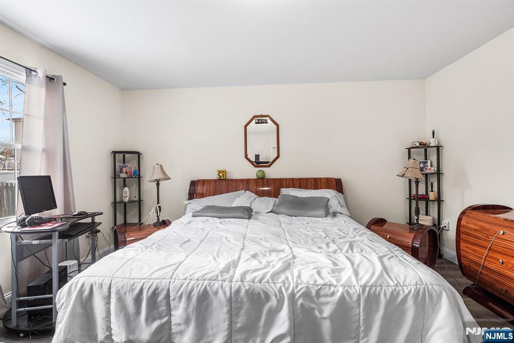 128 Baltimore Avenue Hillside, NJ 07205 - Photo 31 of 50 a bedroom with bed a table and a piano