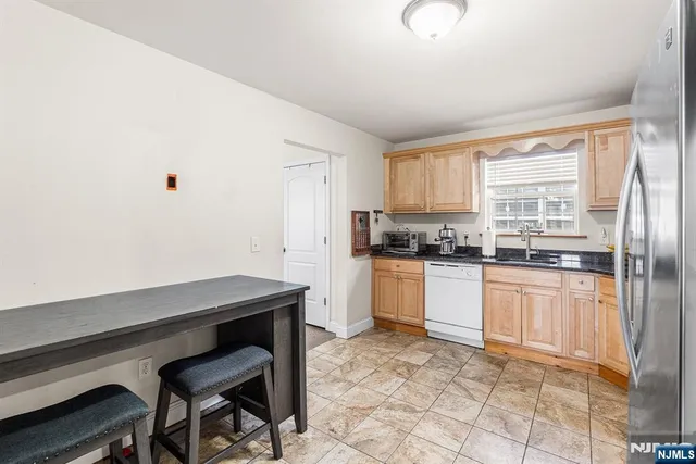 a kitchen with stainless steel appliances granite countertop a refrigerator sink and cabinets