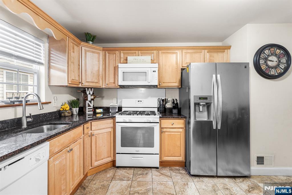 128 Baltimore Avenue Hillside, NJ 07205 - Photo 44 of 50 a kitchen with stainless steel appliances granite countertop a refrigerator a stove and a sink