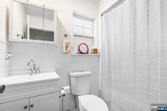 a white house with table and chairs in front of it