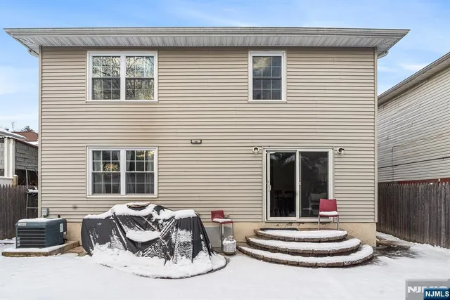 a front view of a house with outdoor seating