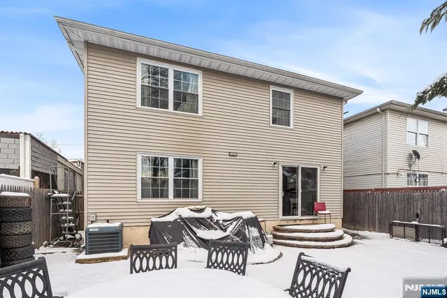 a view of a patio with table and chairs with wooden fence and plants