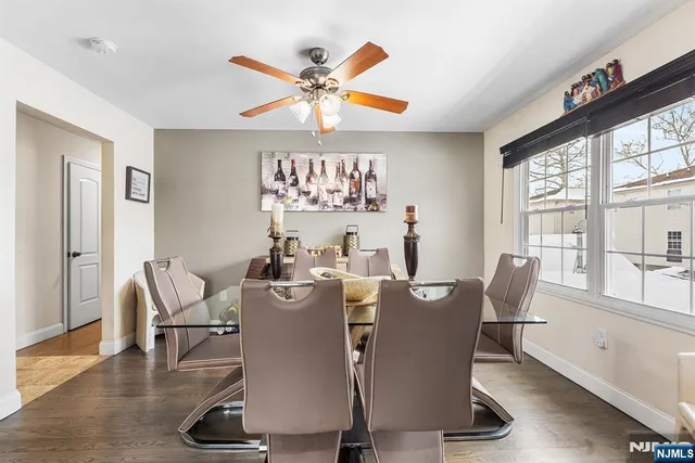 a dining room with furniture window and wooden floor
