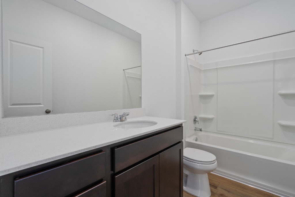 230 Gabbro Gardens Maxwell, TX 78656 - Photo 12 of 24 a bathroom with a sink a toilet and shower