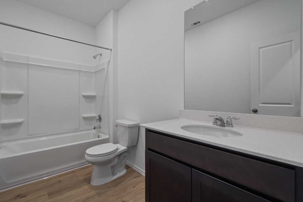 230 Gabbro Gardens Maxwell, TX 78656 - Photo 18 of 24 a bathroom with a sink a toilet and shower