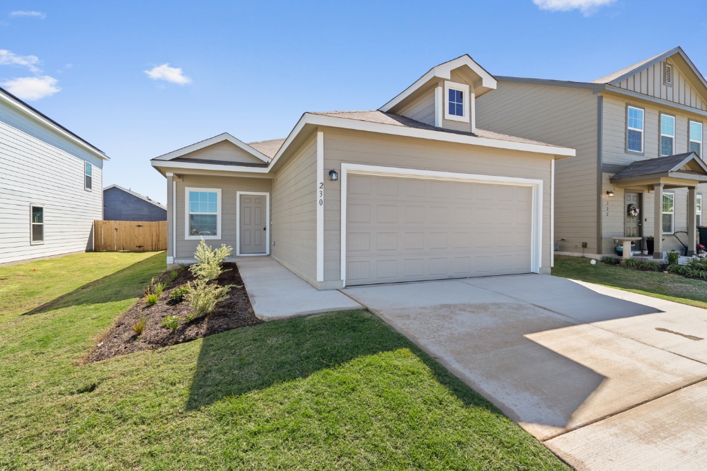 230 Gabbro Gardens Maxwell, TX 78656 - Photo 3 of 24 a front view of a house with a yard and garage