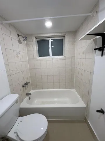 a bathroom with a toilet and a bathtub