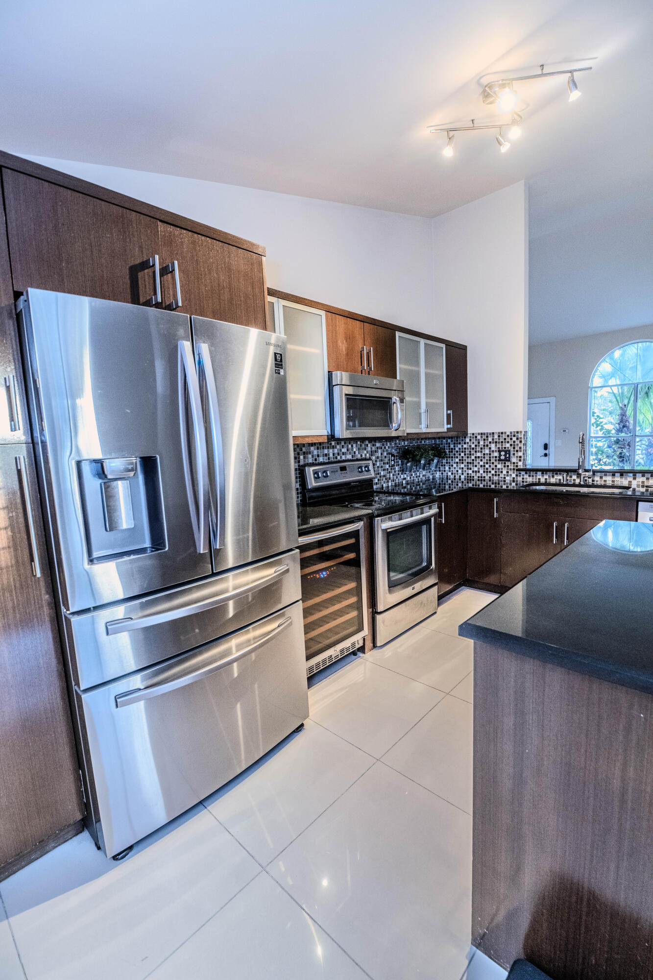 8111 Cedar Hollow Lane Boca Raton, FL 33433 - Photo 11 of 26 a kitchen with stainless steel appliances granite countertop a refrigerator and a stove top oven