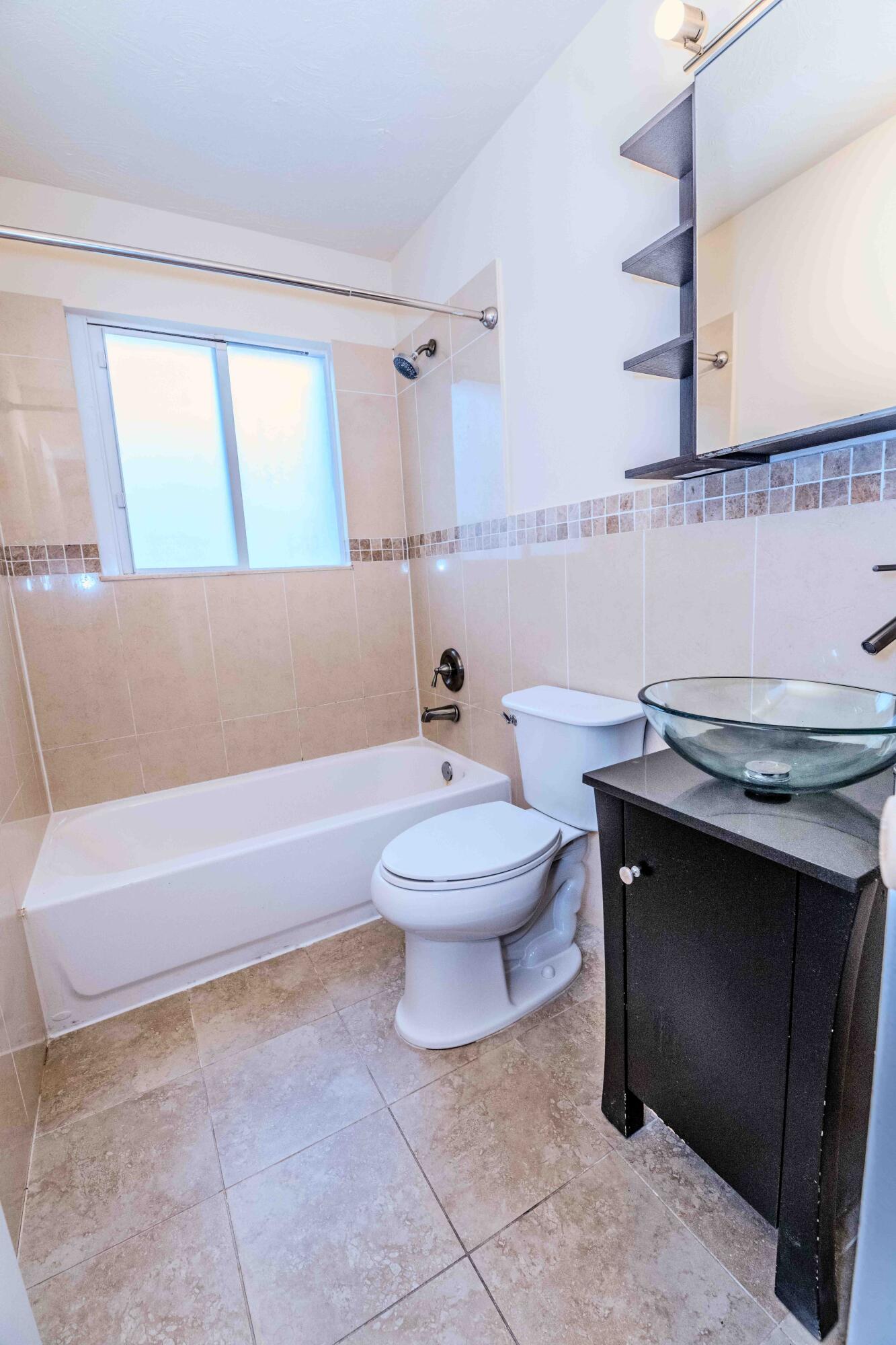 8111 Cedar Hollow Lane Boca Raton, FL 33433 - Photo 18 of 26 a bathroom with a sink a toilet and a bathtub