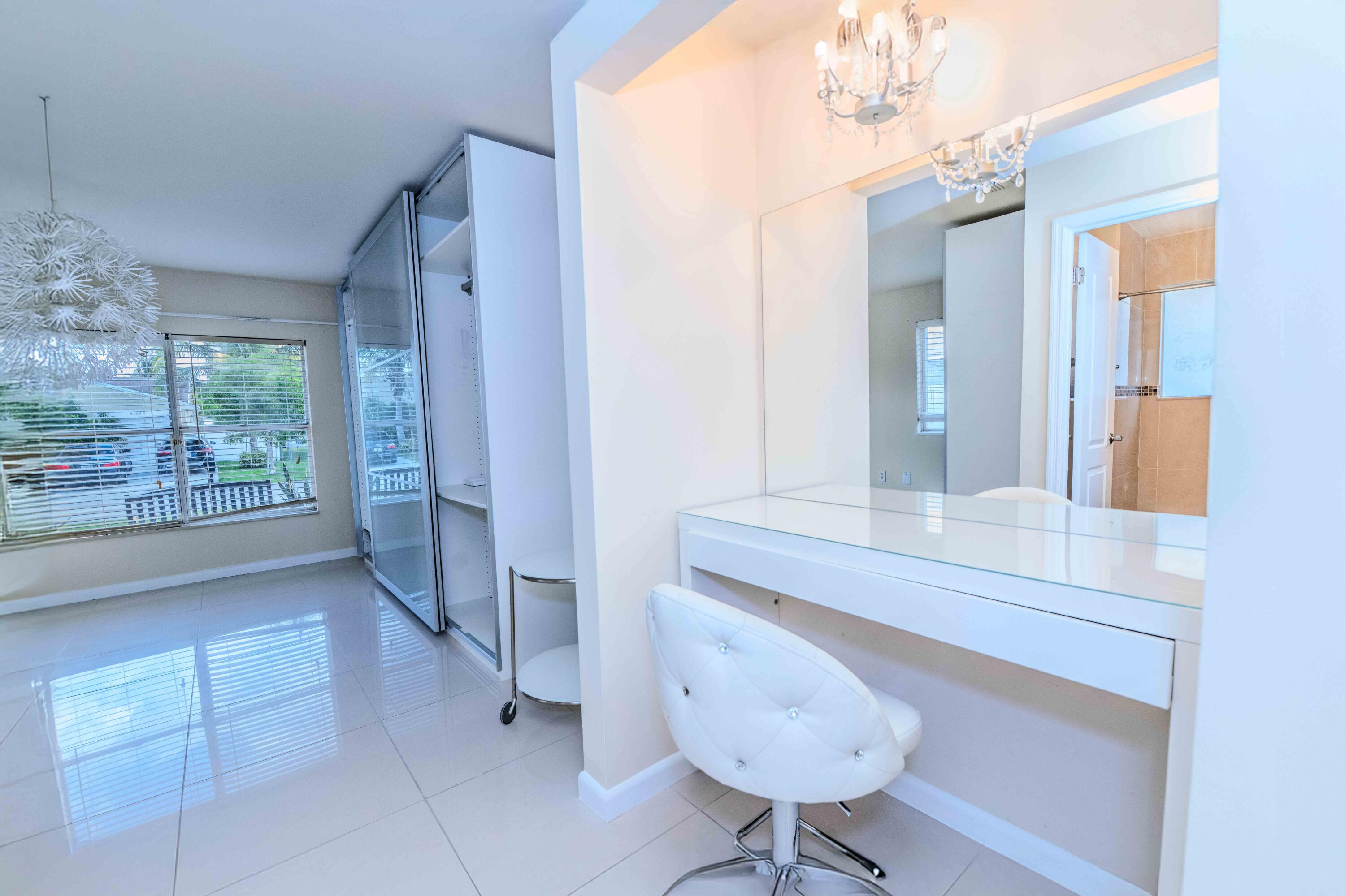 8111 Cedar Hollow Lane Boca Raton, FL 33433 - Photo 19 of 26 a bathroom with a sink a mirror and a bathtub