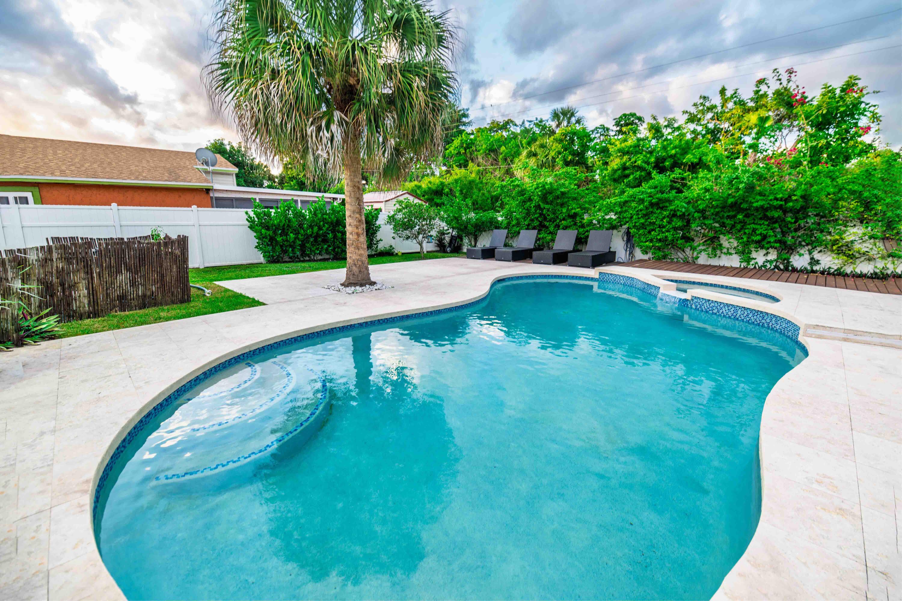 8111 Cedar Hollow Lane Boca Raton, FL 33433 - Photo 2 of 26 a view of a swimming pool with a yard